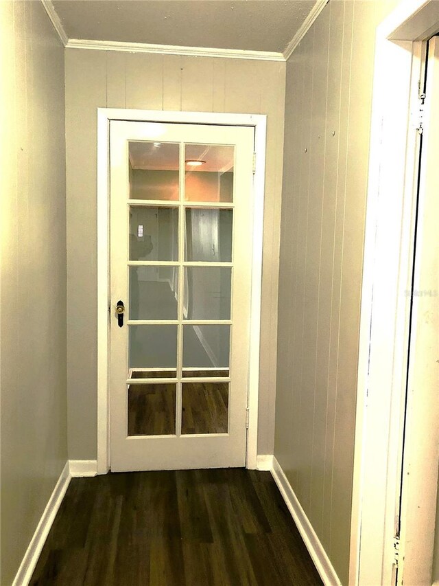 hallway with crown molding and dark hardwood / wood-style floors