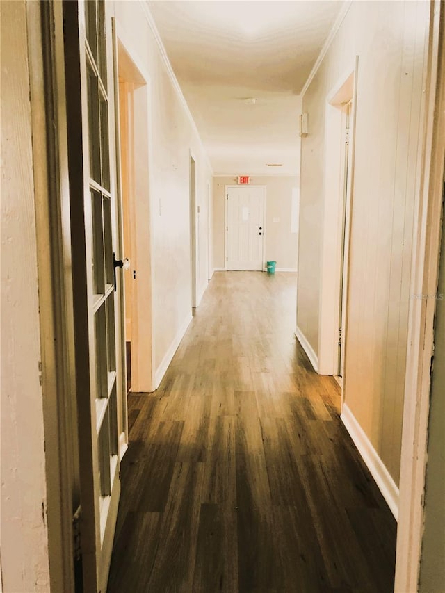 hallway with hardwood / wood-style flooring and ornamental molding