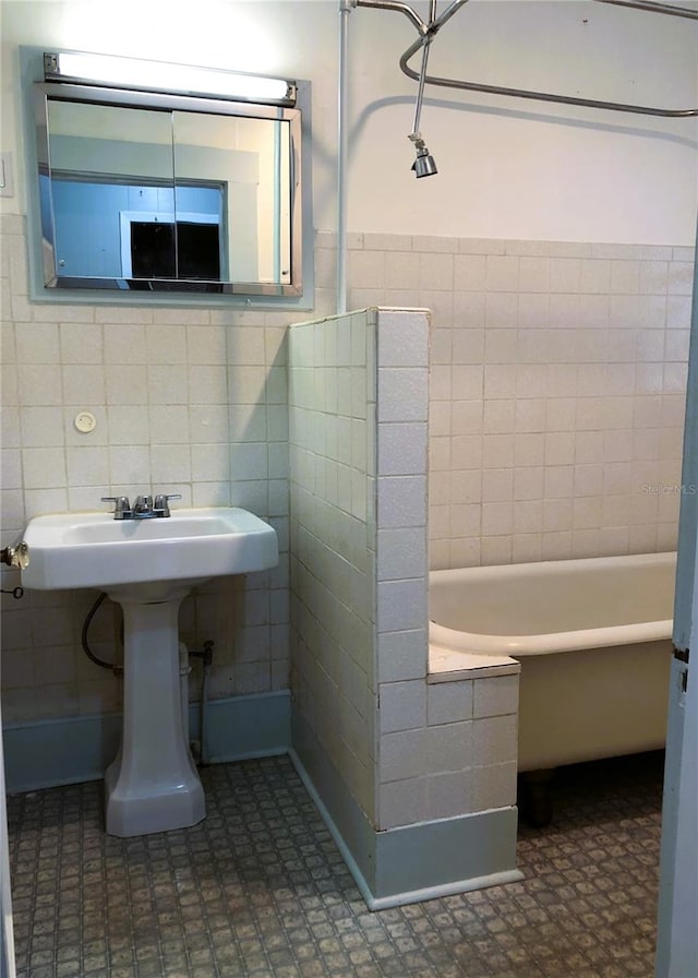 bathroom with tile patterned flooring and tile walls