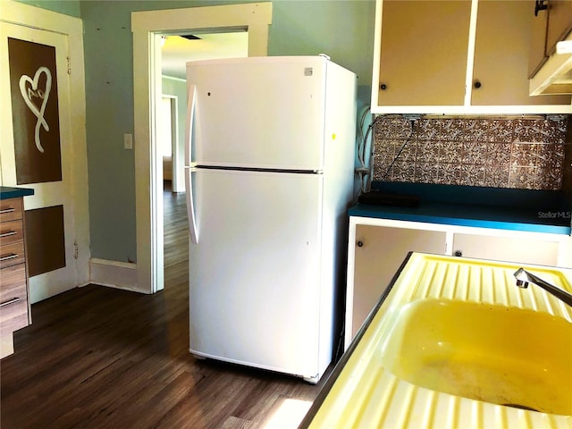 kitchen with dark hardwood / wood-style floors and white refrigerator