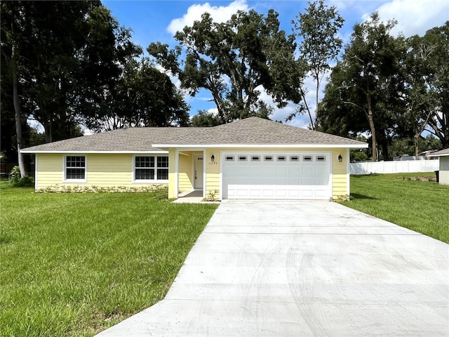 single story home with a front yard and a garage