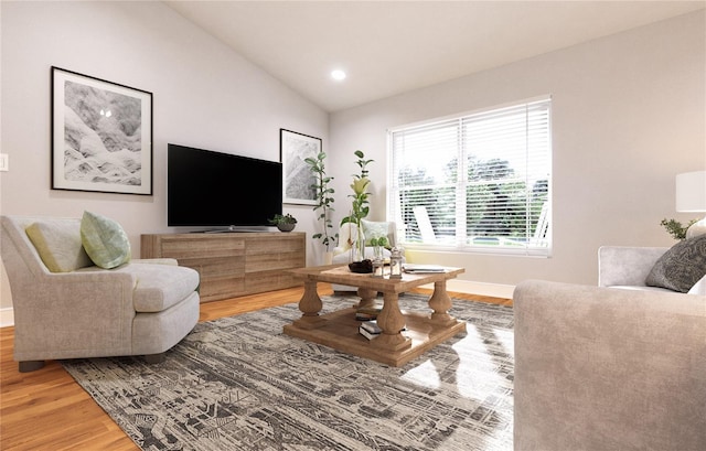 living room with vaulted ceiling and hardwood / wood-style floors