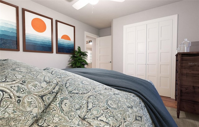 carpeted bedroom featuring a closet and ceiling fan