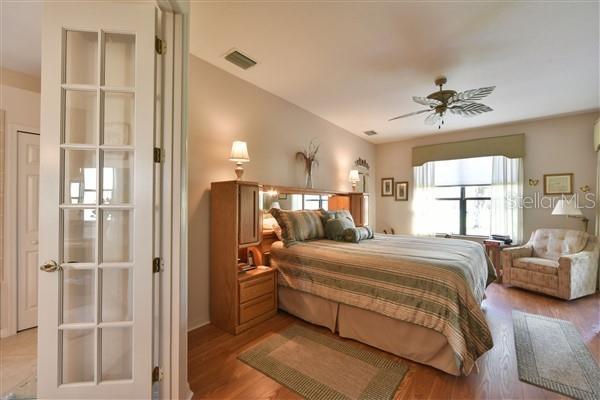 bedroom with light hardwood / wood-style flooring and ceiling fan