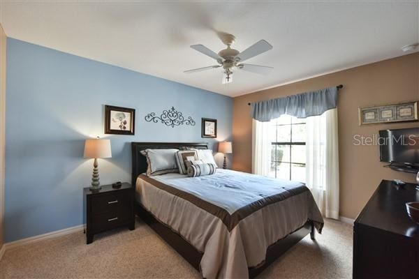 carpeted bedroom with ceiling fan