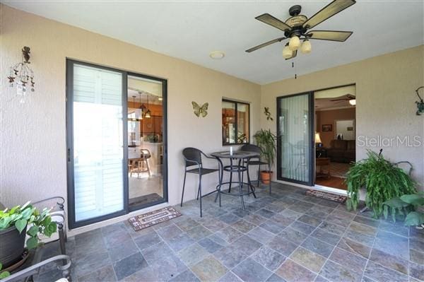 view of patio featuring ceiling fan