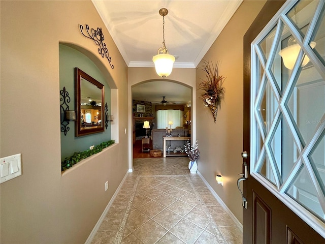 interior space with light tile patterned floors and crown molding