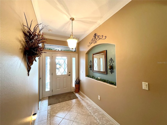 tiled foyer entrance with ornamental molding