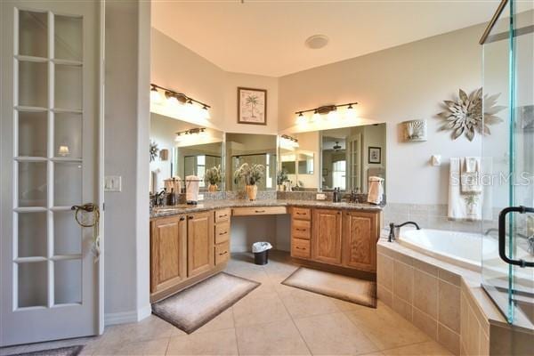 bathroom featuring tile patterned flooring, vanity, and independent shower and bath