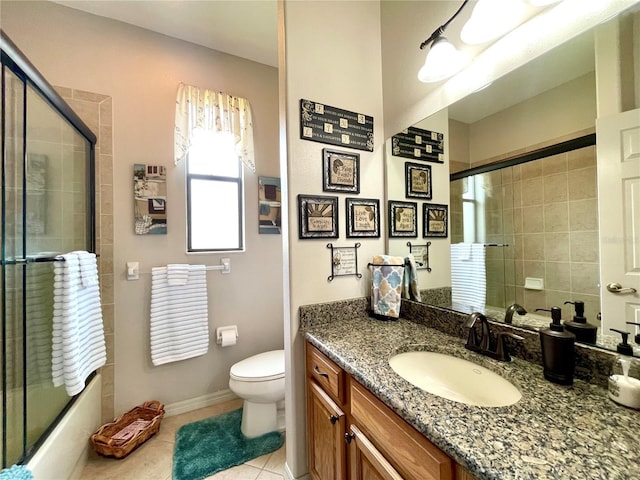 full bathroom with tile patterned flooring, vanity, toilet, and enclosed tub / shower combo