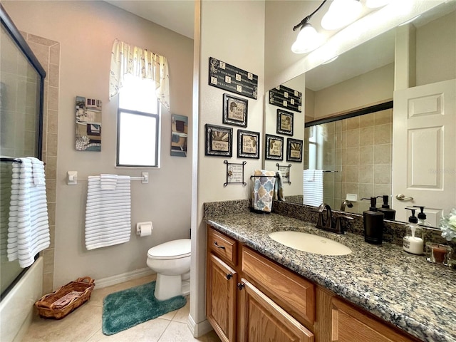 full bathroom featuring tile patterned floors, vanity, toilet, and shower / bath combination with glass door