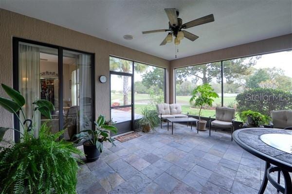 sunroom featuring ceiling fan