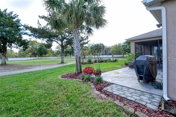 view of yard featuring a patio area and a sunroom