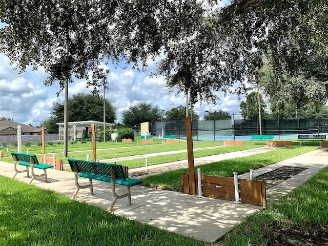 surrounding community with tennis court