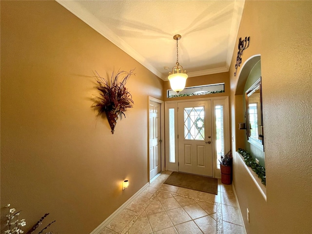 foyer with crown molding and light tile patterned floors