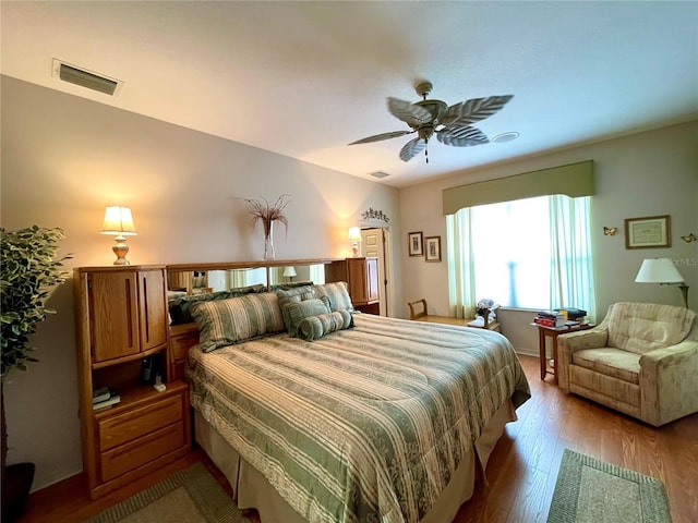 bedroom with ceiling fan and light hardwood / wood-style flooring