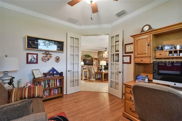 office area with french doors, crown molding, ceiling fan, built in features, and light hardwood / wood-style floors