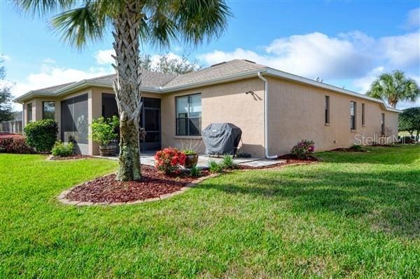 rear view of property with a lawn