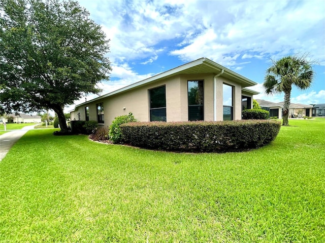 view of side of home with a lawn