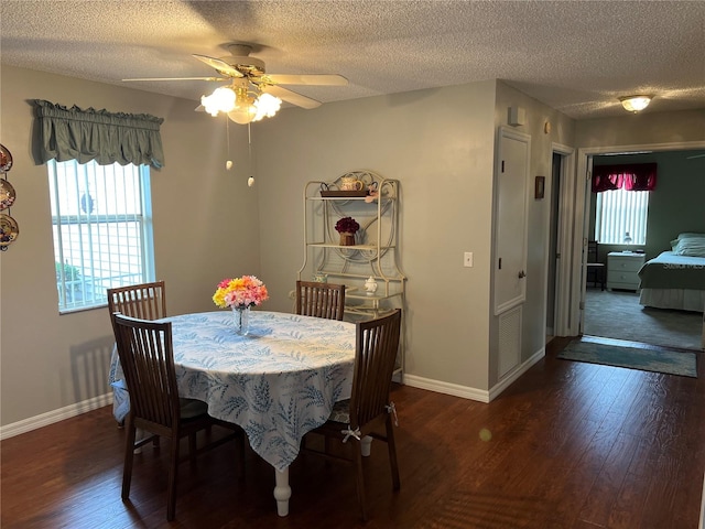 dining area featuring a textured ceiling, dark hardwood / wood-style floors, and ceiling fan