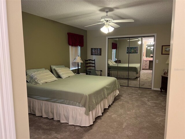 carpeted bedroom with a textured ceiling, a closet, and ceiling fan