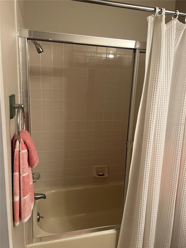 bathroom with shower / bath combo with shower curtain