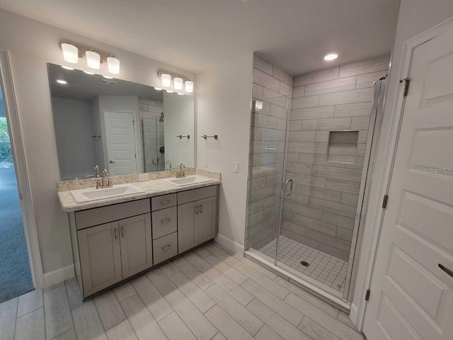 5243 SW 106th St, Ocala, FL 34476 - full bathroom with a shower stall, double vanity, baseboards, wood tiled floors, and recessed lighting