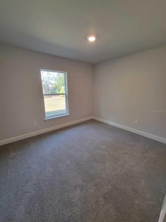 5243 SW 106th St, Ocala, FL 34476 - unfurnished room with baseboards, dark colored carpet, and recessed lighting