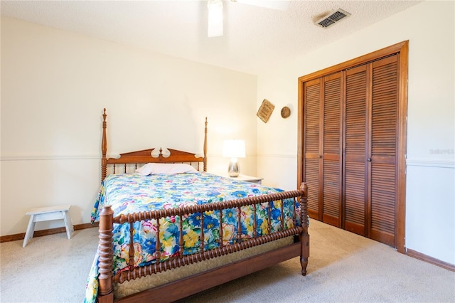 bedroom with ceiling fan, a closet, carpet floors, and a textured ceiling