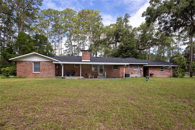 back of property featuring a lawn