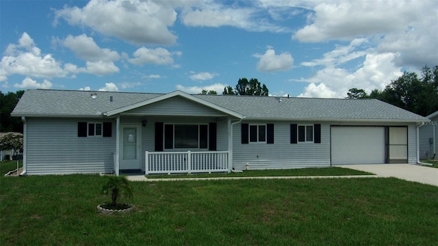 single story home with covered porch, a garage, and a front yard