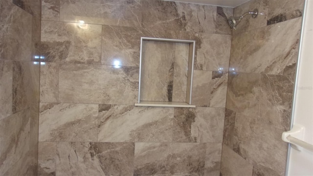 interior details with a tile shower