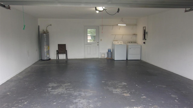 garage featuring electric panel, gas water heater, and independent washer and dryer