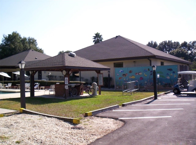 view of vehicle parking featuring a gazebo and a yard