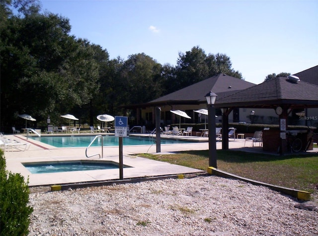 view of swimming pool with a gazebo and a patio