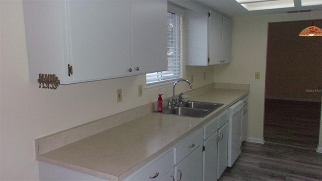 kitchen with dark hardwood / wood-style flooring, sink, white cabinets, and white dishwasher