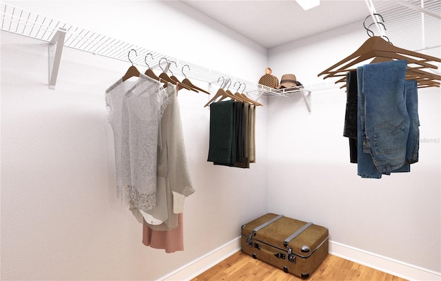 spacious closet with hardwood / wood-style floors