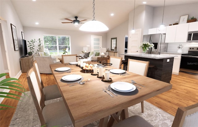 dining space featuring high vaulted ceiling, ceiling fan, and light hardwood / wood-style flooring