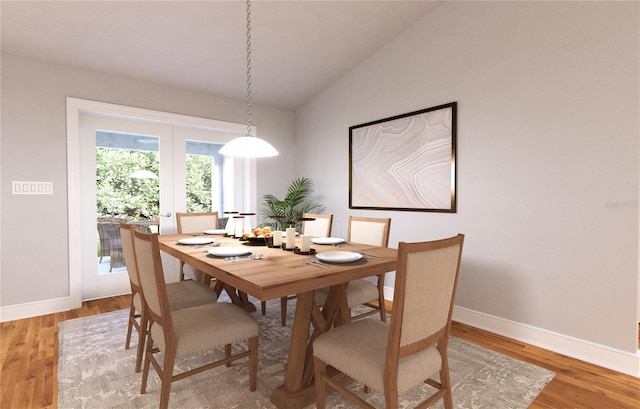 dining area featuring light hardwood / wood-style floors, french doors, and lofted ceiling