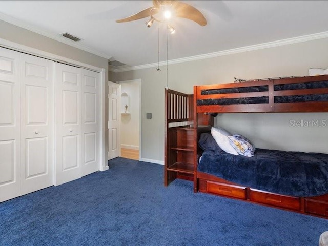 unfurnished bedroom with dark colored carpet, a closet, ceiling fan, and ornamental molding