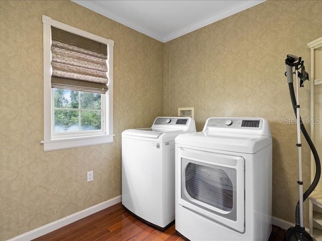 washroom with wood-type flooring, independent washer and dryer, and ornamental molding