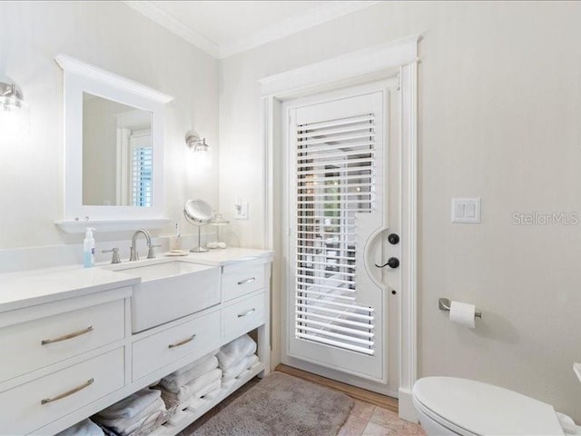 bathroom featuring crown molding, vanity, and toilet