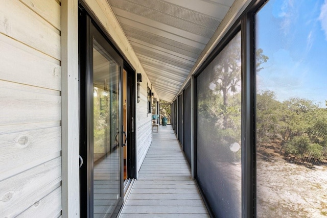 unfurnished sunroom featuring lofted ceiling