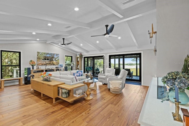 living room featuring light wood-type flooring, french doors, and lofted ceiling with beams