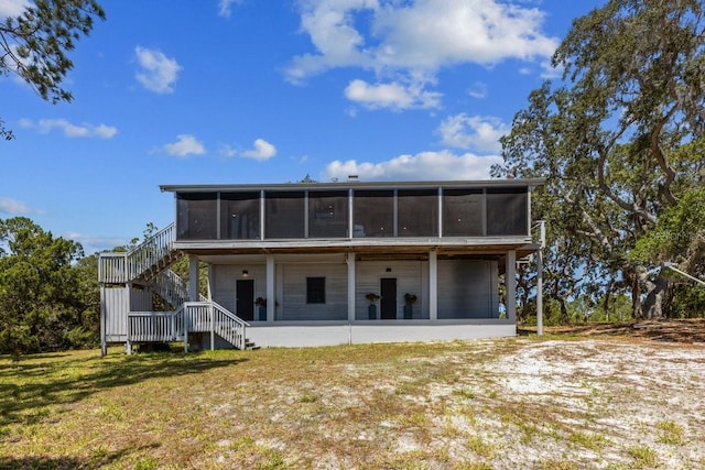 rear view of property with a yard