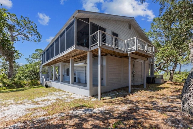 view of property exterior featuring a sunroom