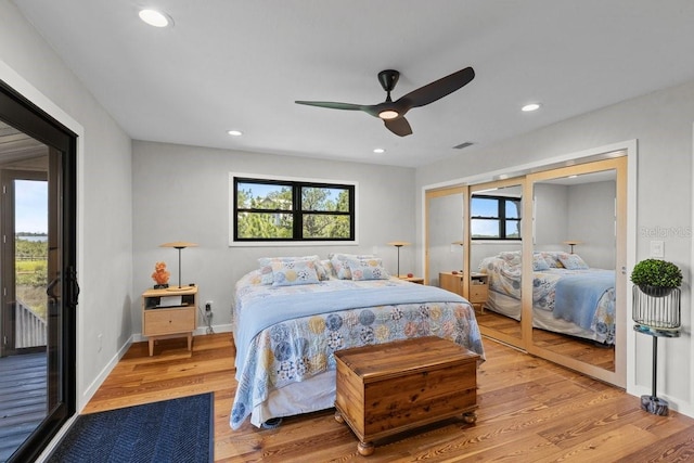 bedroom with hardwood / wood-style flooring, ceiling fan, and access to outside