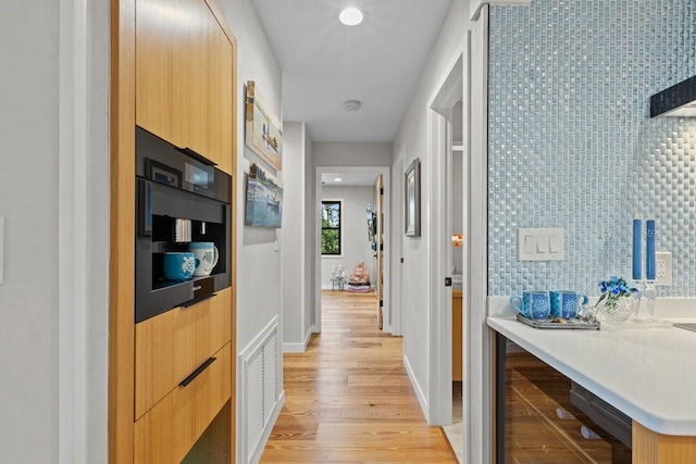 hall with light hardwood / wood-style flooring