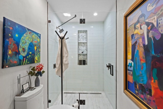 bathroom with an enclosed shower and toilet