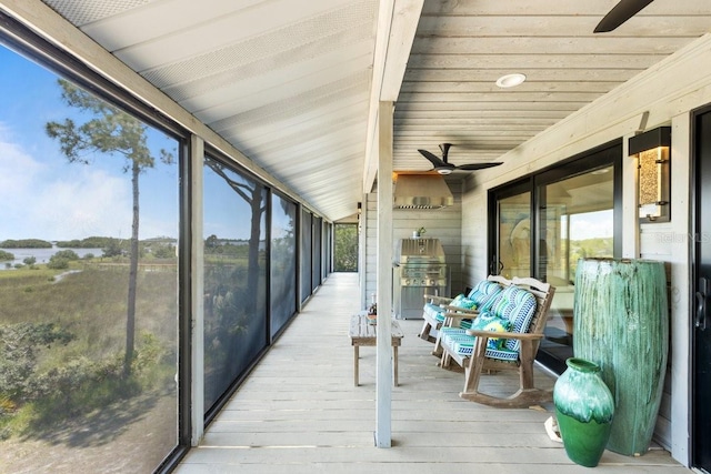 sunroom featuring plenty of natural light, lofted ceiling, and ceiling fan